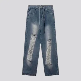 Medium-wash distressed jeans
 for men